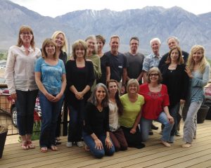 Group photo of participants in Theta healing workshop in front of mountain range - The Flow of Healing.com