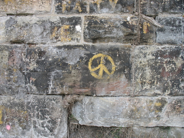 peace sign on stone wall